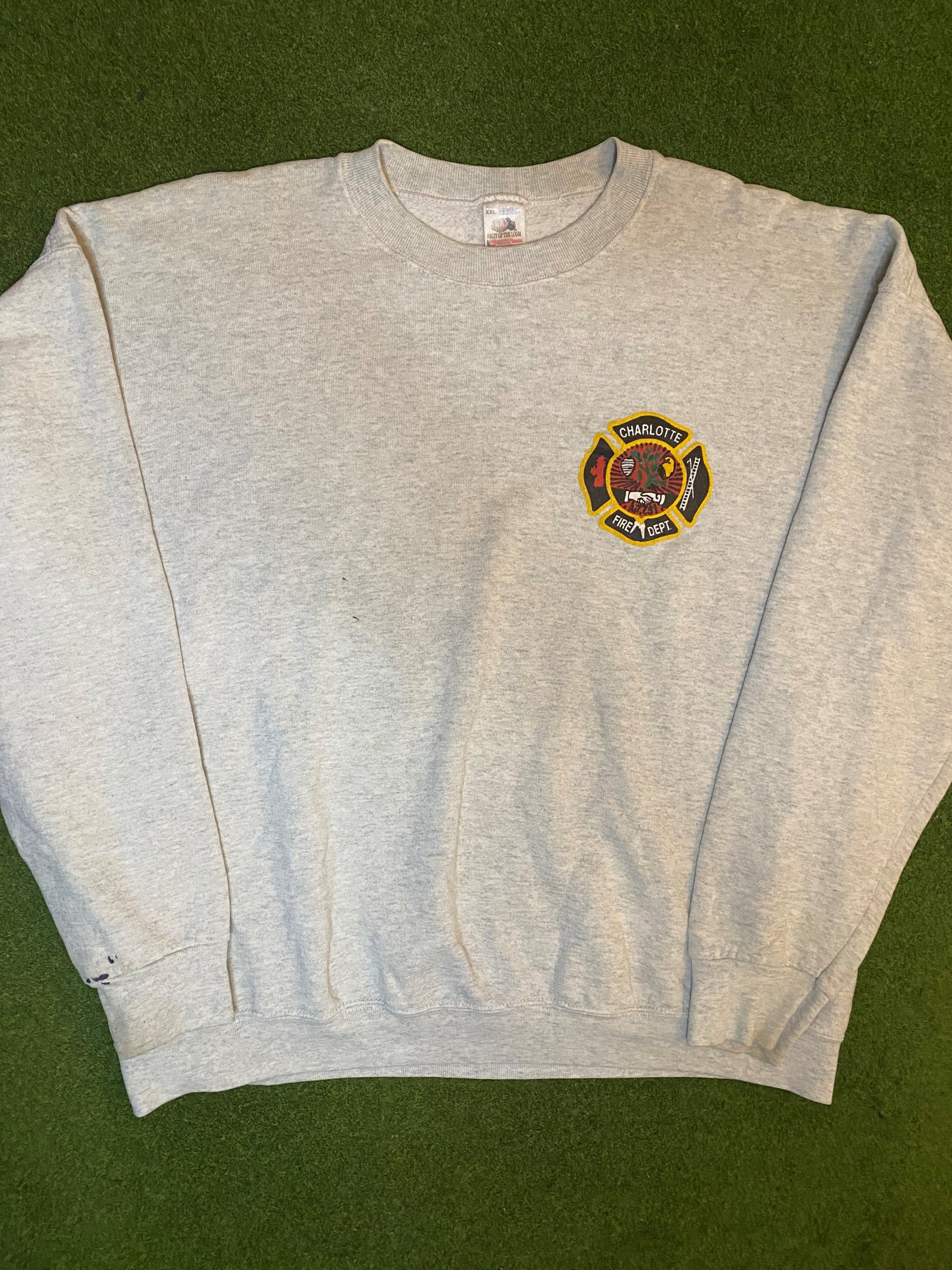 a grey sweatshirt with a firefighter emblem on it